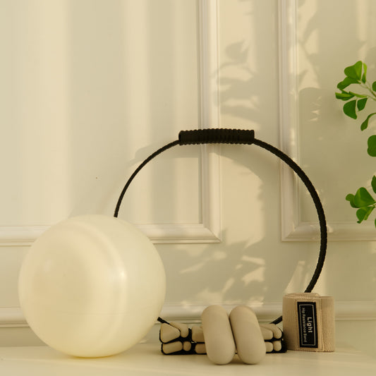 A small considered collection of pilates equipment on a linen surface